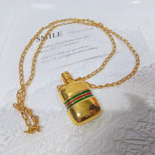 Gucci bottle necklace gold Perfume